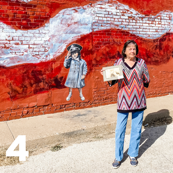 little girl saluting mural