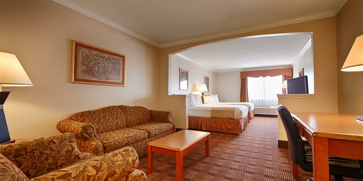 Interior of Best Western Club House Inn & Suites hotel room with beds and desk
