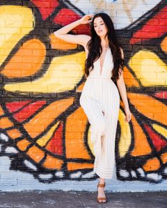 Model posing in front of mural