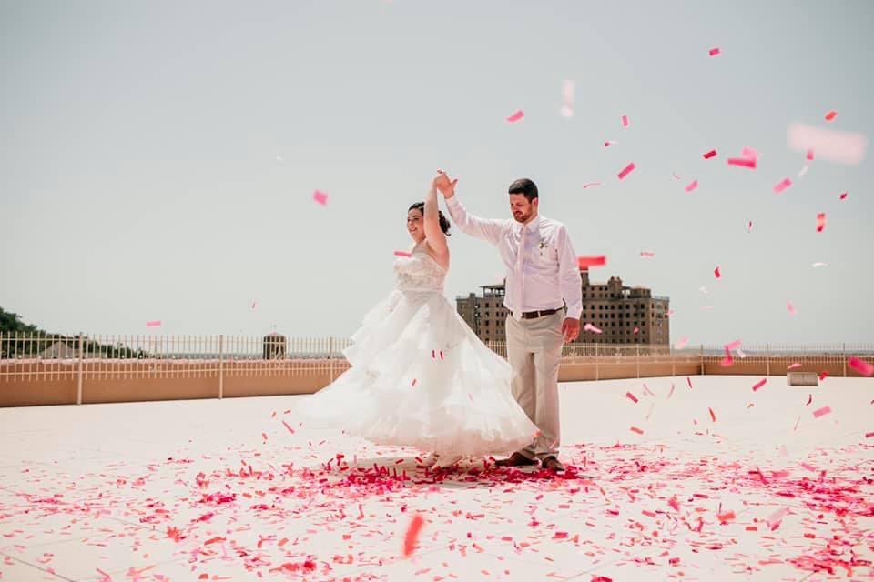 Wedding couple on rooftop with flowers