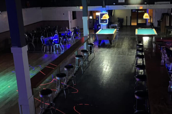 940 dance hall with chairs and pool tables.