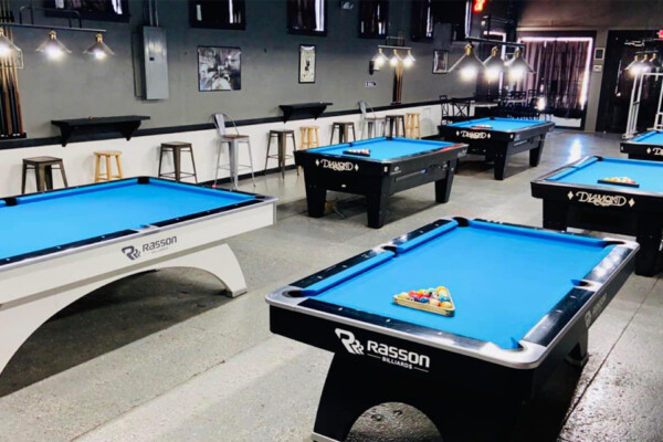 Legends pool hall with view of six pool tables.
