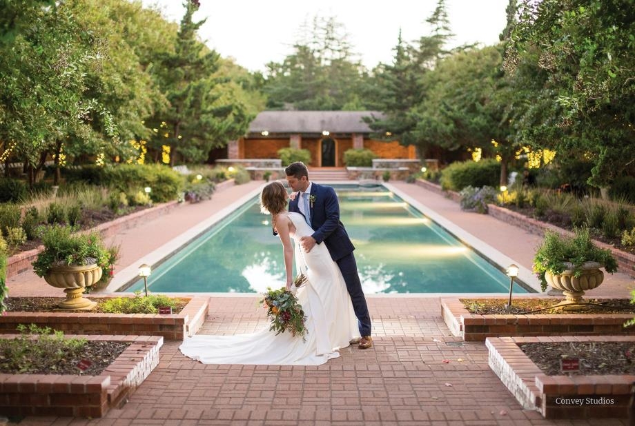 Groom Kissing bride in front of pond photo Credit: Convey Studios