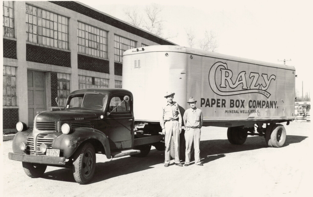Two men stand in front of Crazy Paper Box Company