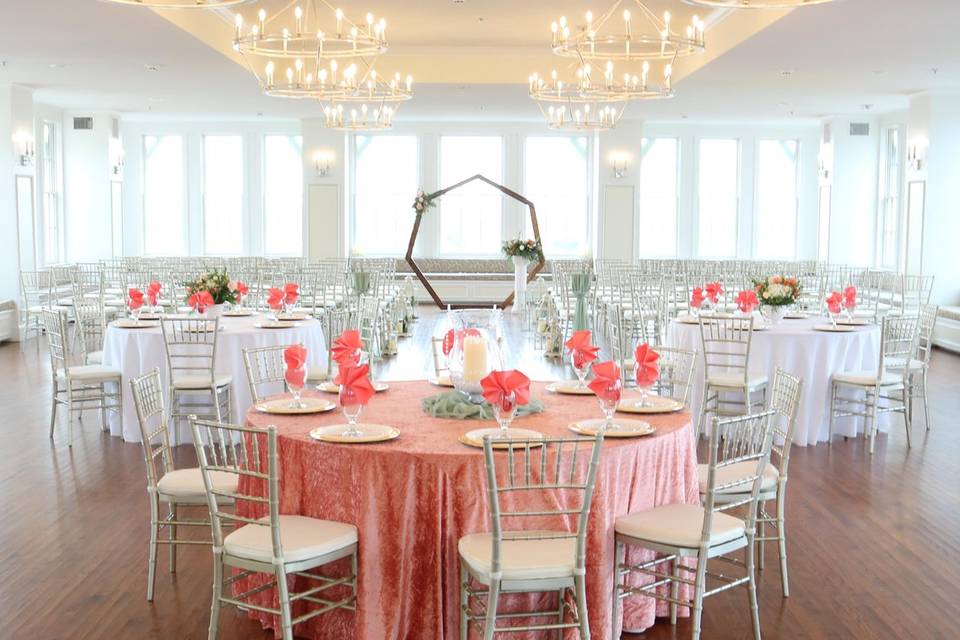 Wedding ballroom set up with chairs, tables and flowers