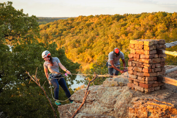 Man and woman rock climbing in Lake Mineral Wells State Park