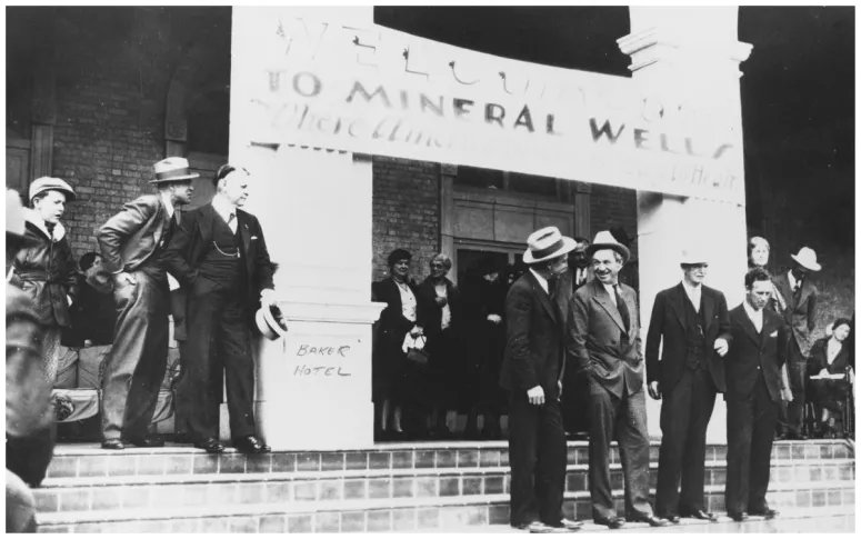 Will Rogers visits Mineral Wells. Will Rogers 2nd left center and Mayor Charleton Brown 3rd front and a group of people on the front steps of Baker Hotel