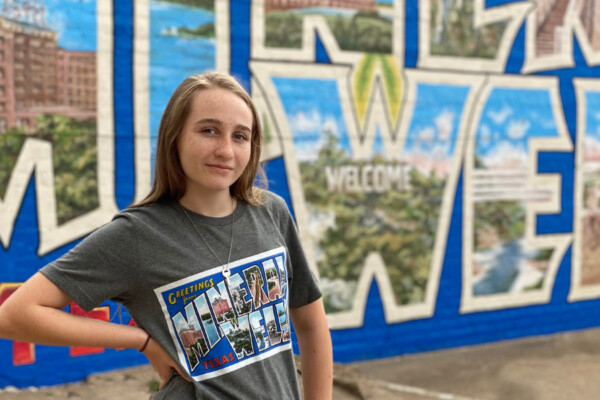 Girl posing in front of mural