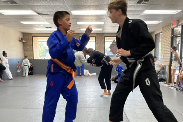 Jiu Jitsu competitors on mat sparring at Heart & Dagger