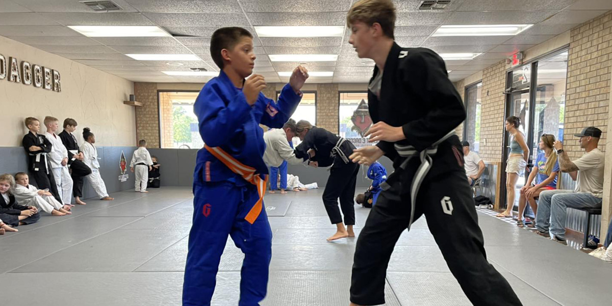 Jiu Jitsu competitors on mat sparring at Heart & Dagger