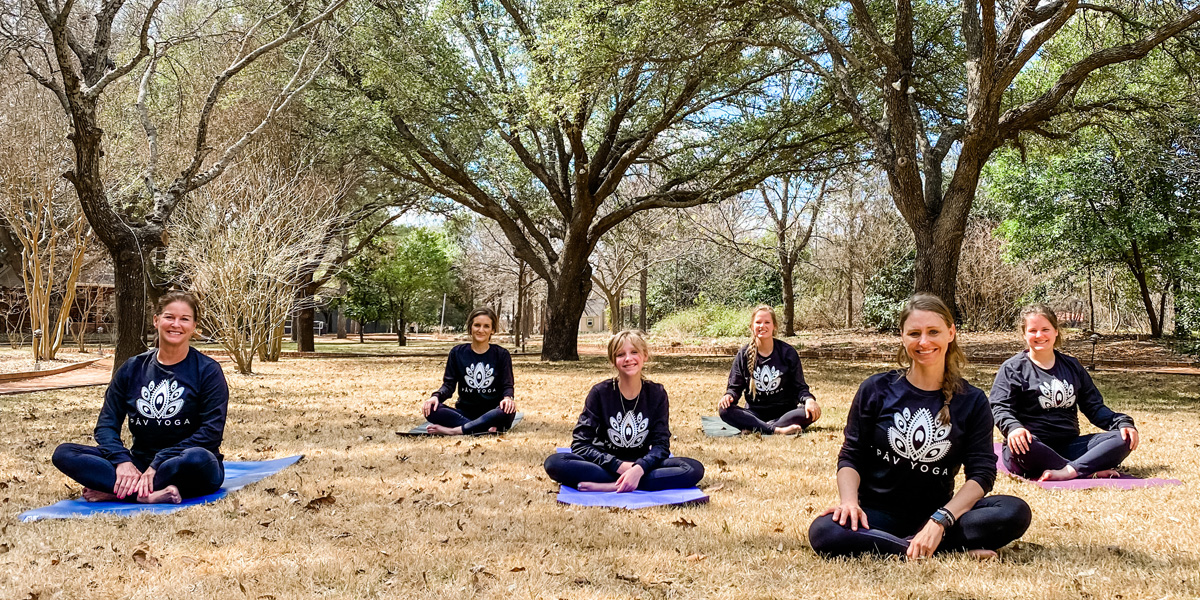 PAV Yoga classes in field under trees