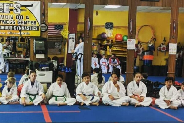 Zee's American Tae Kwon martial art students sitting on mat