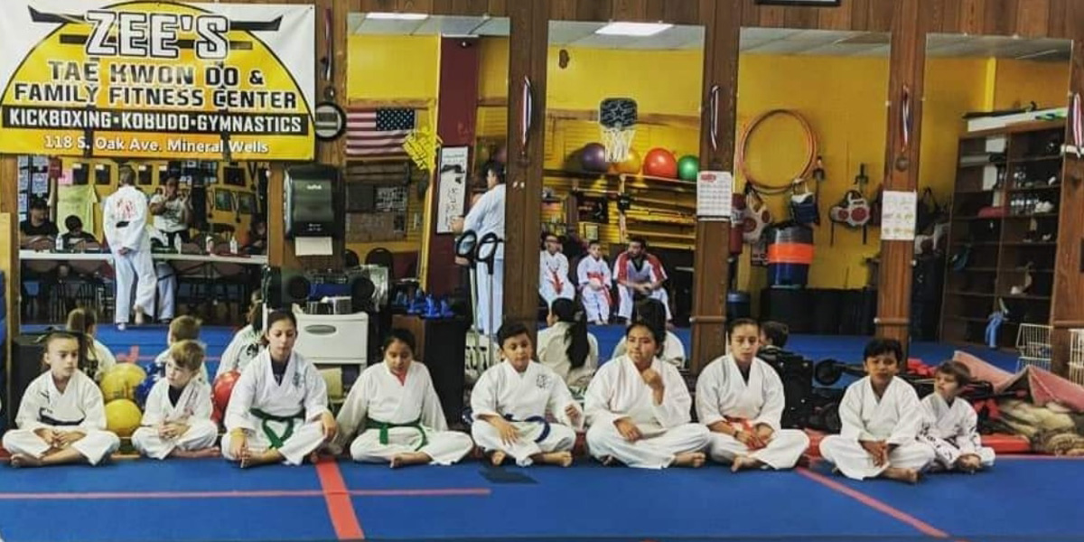 Zee's American Tae Kwon martial art students sitting on mat